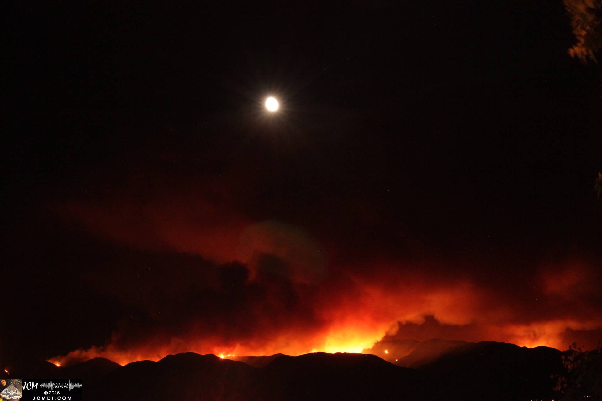Sand fire long-exposure night image with bloody moonrise JCMDI.COM